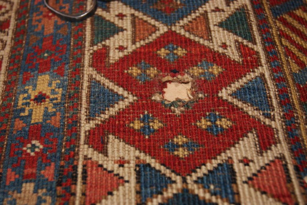 This is an old kazak rug, which had a hole. Using our expert knowledge, we managed to weave it back into place, looking good as knew.